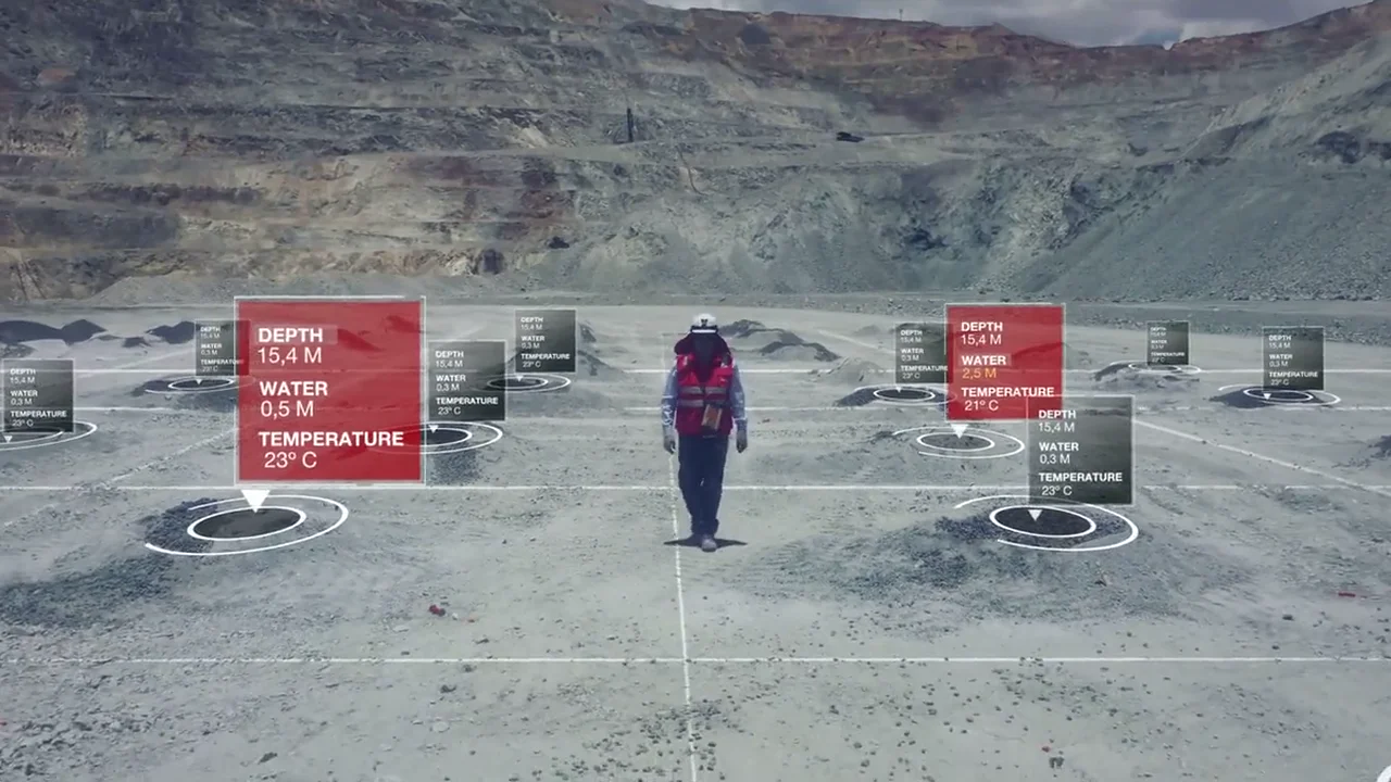 Bright Scan demo video: a field engineer standing on a drilled bench where every blasthole carries its own depth, water and temperature readout.